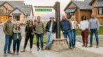 Four pairs of designers and a host stand on a Denver street looking at camera