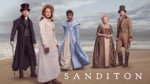 Five people in regency dress on a beach