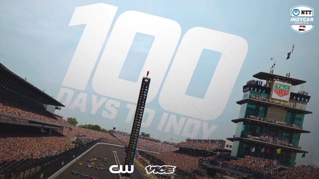 Show title logo slants in sky over the race track of the Indianapolis 500