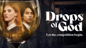 A French woman and Japanese man both in black suits reflected in a wine glass.