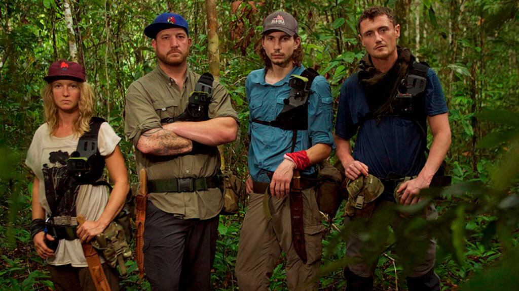 Four scrappy looking miners deep in a wooded area