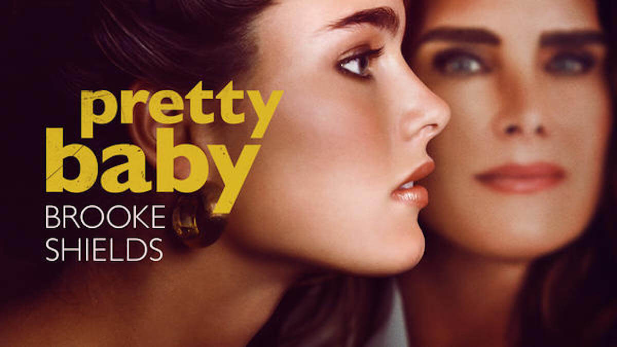 Profile of young Brooke Shields with the actress looking at camera behind her.