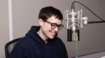 Actor Elliot Page laughing at a microphone