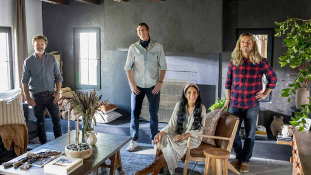 Four hip designers pose in a modern living room.
