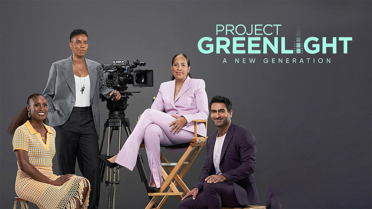 A group of four filmmakers of color around a camera and director's chair
