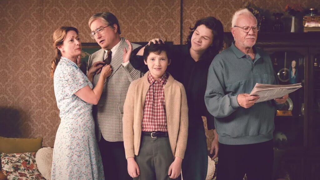 Awkward family photo showing three generations in retro clothing