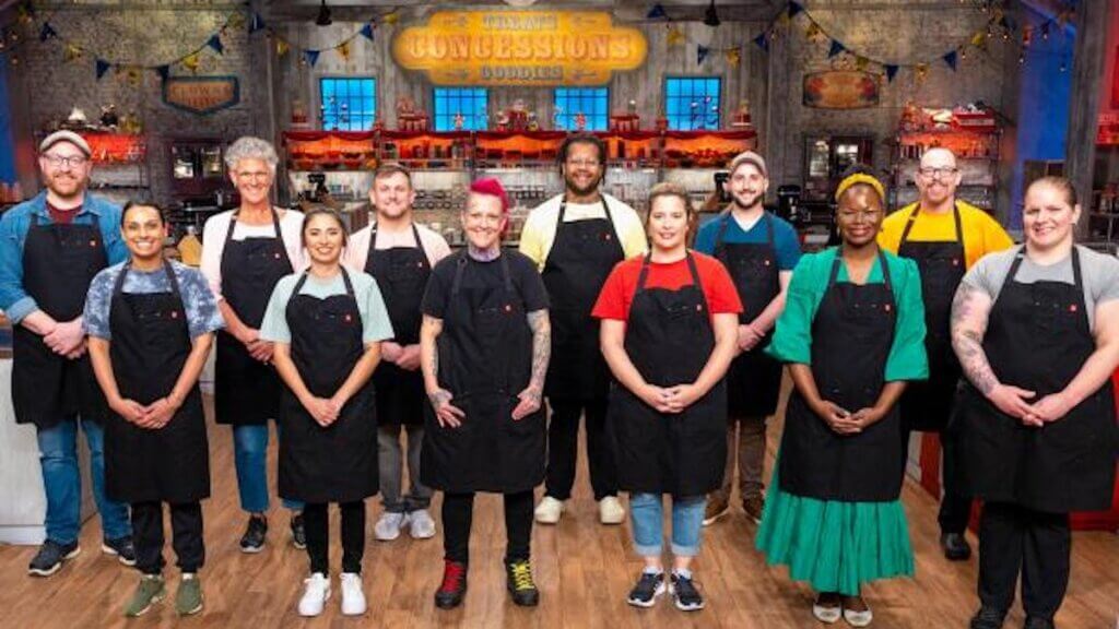 12 chefs in a creepy kitchen wearing black aprons