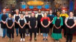 12 chefs in a creepy kitchen wearing black aprons