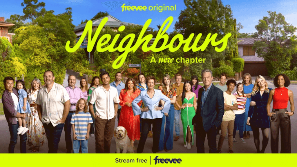 A large ensemble cast posed in a quaint cul-de-sac neighborhood