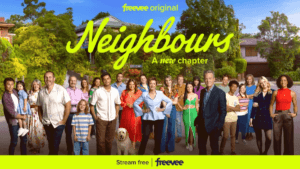 A large ensemble cast posed in a quaint cul-de-sac neighborhood