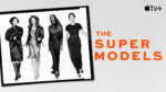 A black and white shot of four iconic super models walking towards the camera, framed in a photo negative frame