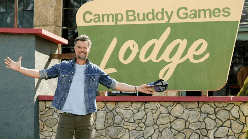 Actor and host Josh Duhamel in front of a Lodge labeled Buddy Games