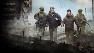 Actor Sean Penn and Ukraine president Zelenskyy walking through city rubble with armed military guards
